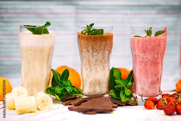Fototapeta milkshake with berries and fruits on a decorated table