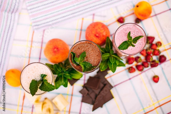Fototapeta milkshake with berries and fruits on a decorated table