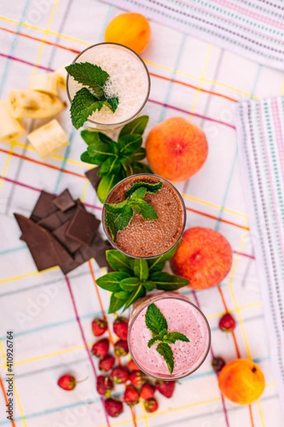 Fototapeta milkshake with berries and fruits on a decorated table