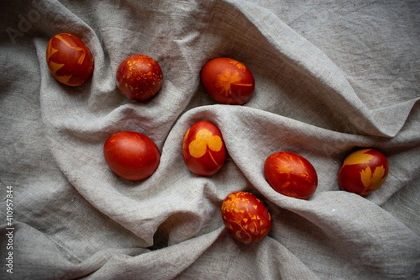 Fototapeta Easter Eggs Decorated with Natural Fresh Leaves and Boiled in Onions Peels on gray linen tablecloth. Happy Easter concept. Eco Easter eggs.  Zero waste Easter.