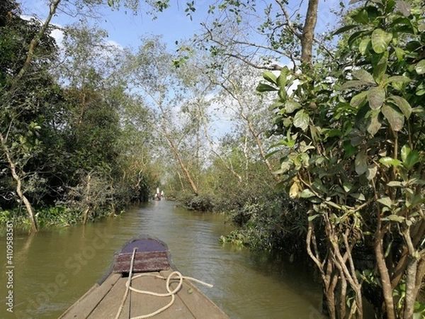 Obraz Green and lush backwaters of the river Mekong with a dettail of a wooden row boat