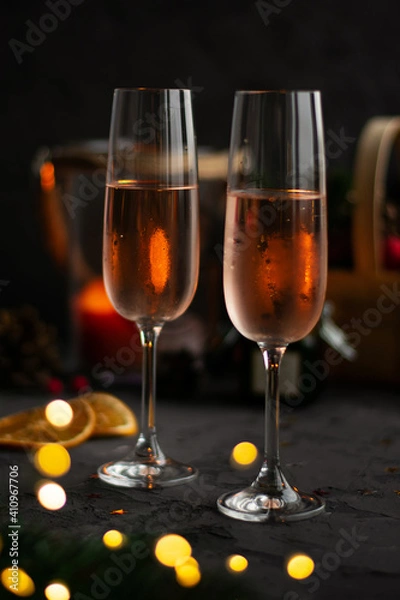 Fototapeta Glasses of rose champagne on blurred dark backgrounde, bokeh . Celebration concept. New year. Valentines day.