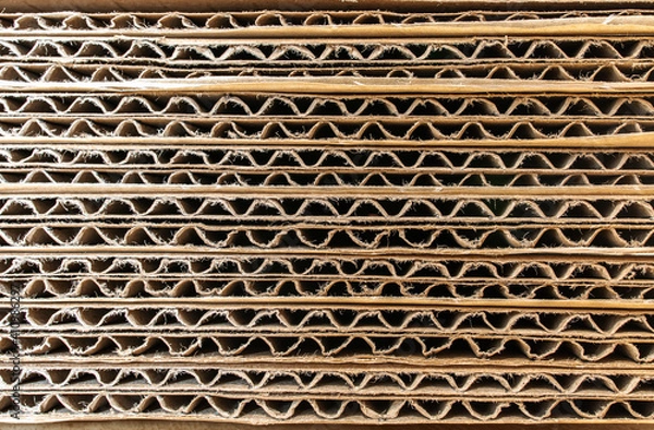 Fototapeta Endless side view of brown container paper box packaging material from shipping industrial. Recycle paperboard. Abstract art of wave striped horizontal lines texture.