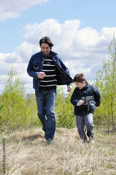 Fototapeta Dad and son relaxing outdoors