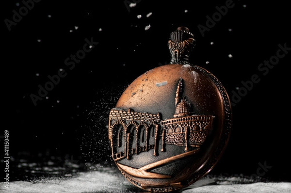 Fototapeta Vintage watch on a black background with falling snow. An idea for Christmas themes, historical themes, and an idea for time management themes