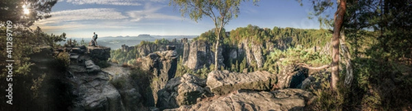 Fototapeta Hiking during sunrise at the Bastei bridge above the Elbe River in the Elbe Sandstone Mountains of Germany. One of the most spectacular hiking regions in Europe. 