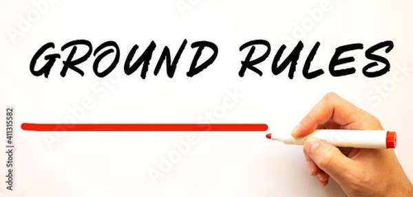 Fototapeta Hand writing GROUND RULES with red marker. Isolated on white background.