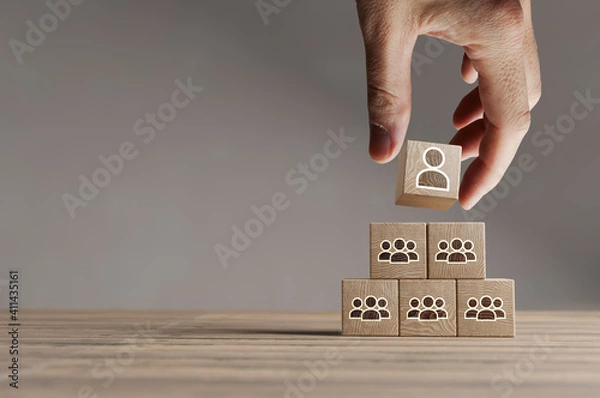 Obraz Wood cubes with new head of team or CEO on a beautiful wooden table, studio background. Business concept and copy space.