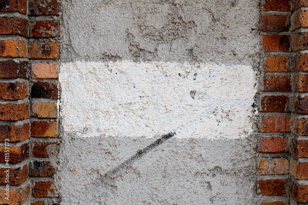 Obraz white concrete wall surrounded by bricks