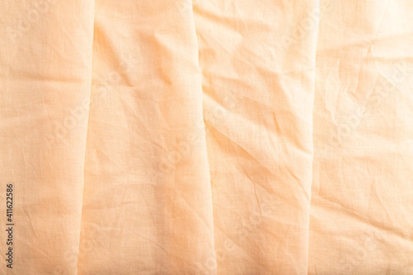 Fototapeta Fragment of orange linen tissue. Top view, natural textile background.