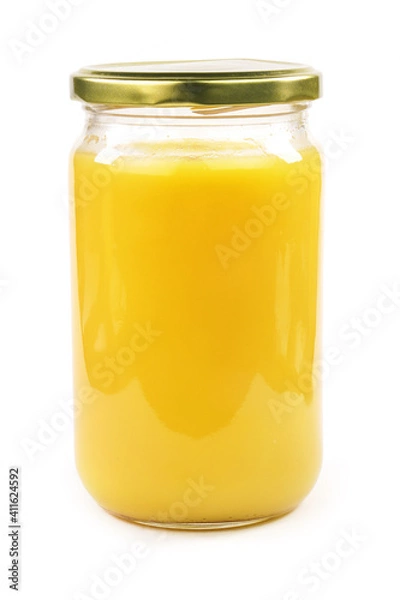 Obraz Homemade ghee in jar and wooden spoon .   Ghee is purified butter.    isolated on white background. 