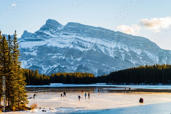 Obraz Beautiful view of people ice-skating on the Two Jack Lake in Banff national park, Canada