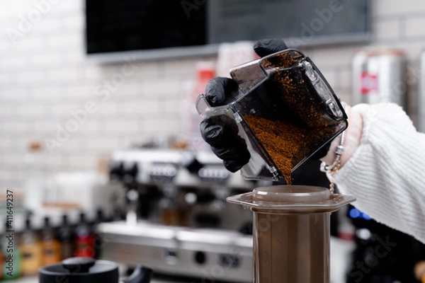 Fototapeta Making press coffee. Add coffe over natural background.