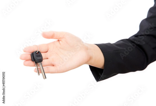 Obraz In front of the white background, one hand holds the door key