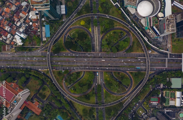 Obraz Top down overhead aerial view of large multi lane roundabout in Jakarta, Indonesia Large traffic junction on a highway with car traffic