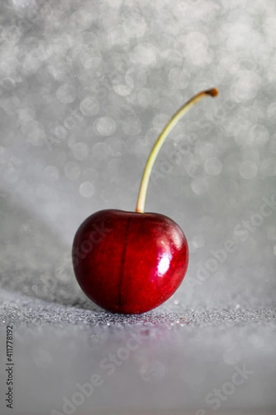 Obraz Closeup one red cherry fruit with root on light grey background with bokeh