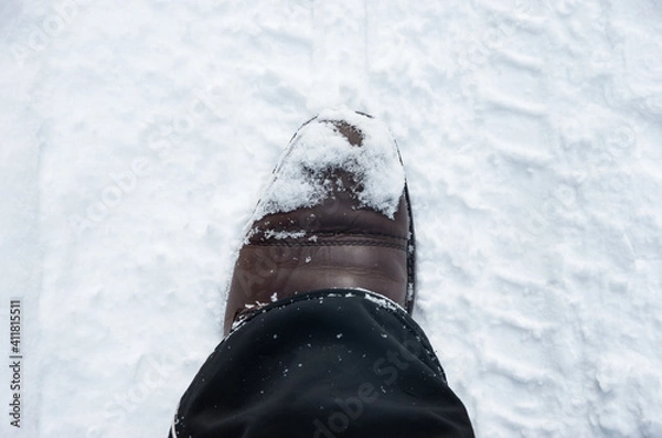 Fototapeta Brown leather shoe, boot in winter in white snow