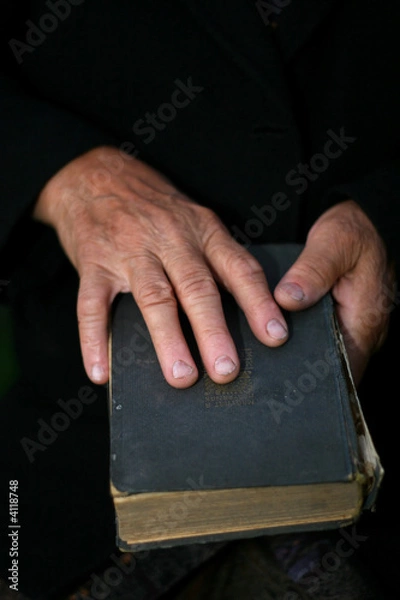 Fototapeta Senior's hands on old book