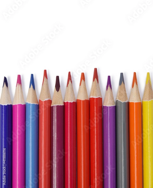 Fototapeta sharpened colored wooden pencils on an white background, top view