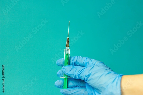 Fototapeta Medical vials for injection, syringe for injection, mask gloves on a blue background. Admission vaccination, flu shot.