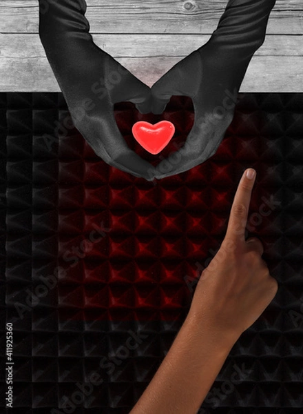 Obraz Two hands hold glowing red heart against dark background