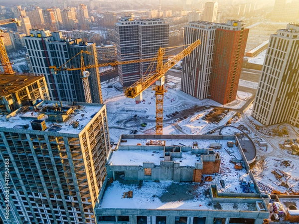 Obraz Building crane on construction site surrounded by new real estates