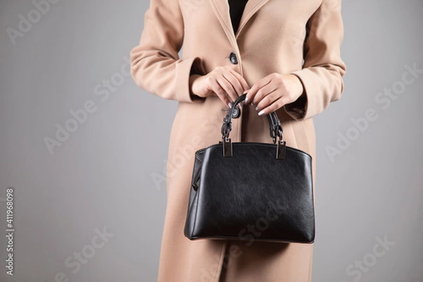 Fototapeta womanin coat holding bag
