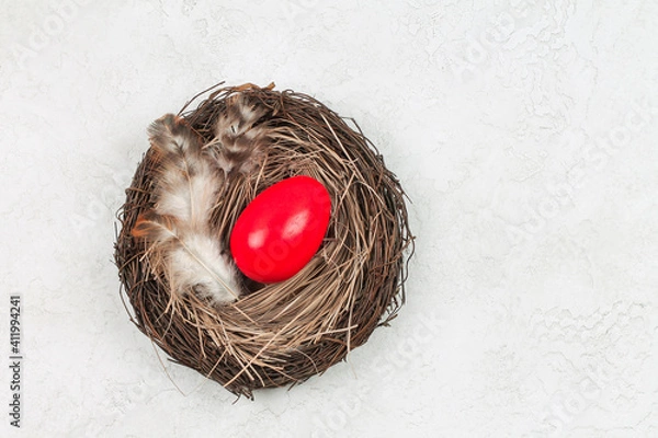 Fototapeta Easter red egg is in the nest. 