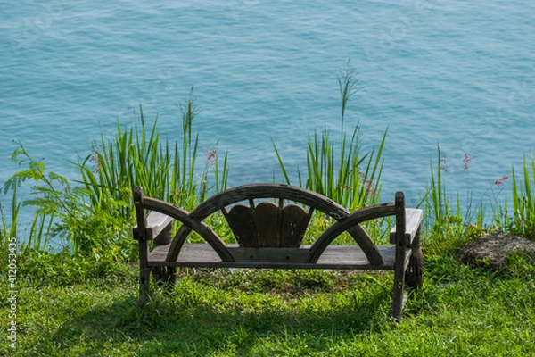 Obraz A chair at the viewpoint on the hill overlooking the sea as calm and beautiful as heaven.