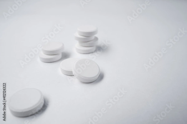 Obraz white pills on white background