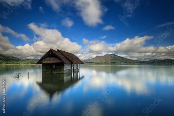 Fototapeta Batur lake, Kintamani, Bali in the morning after sunrise. there is beautiful Batur volcano view with blue sky and perfect reflection in the water.