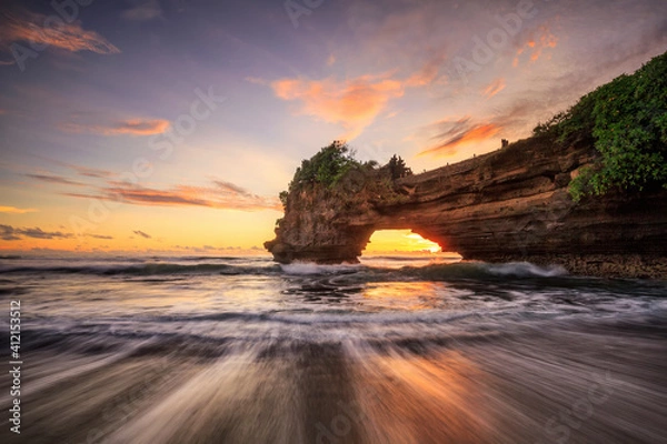 Fototapeta Sunset at Batu Bolong temple and Tanah Lot, Tabanan, Bali. beautiful color view in high tide from the bottom.