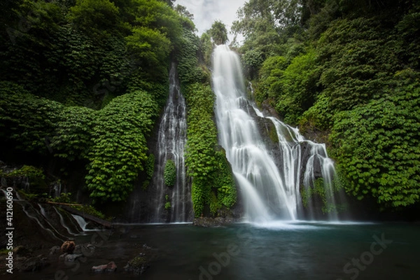 Fototapeta Banyumala waterfall in the north of Bali, that is in Singaraja near Lovina. Jungle waterfall cascade in tropical rainforest with rock and turquoise blue pond. its a twin waterfall in the mountain 