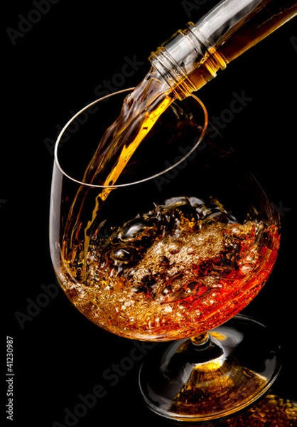 Obraz The glass with splashes cognac