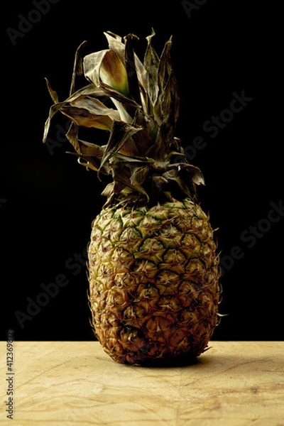Obraz Pineapple over a wooden table