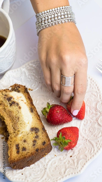 Obraz Hand with strawberry and diamond ring