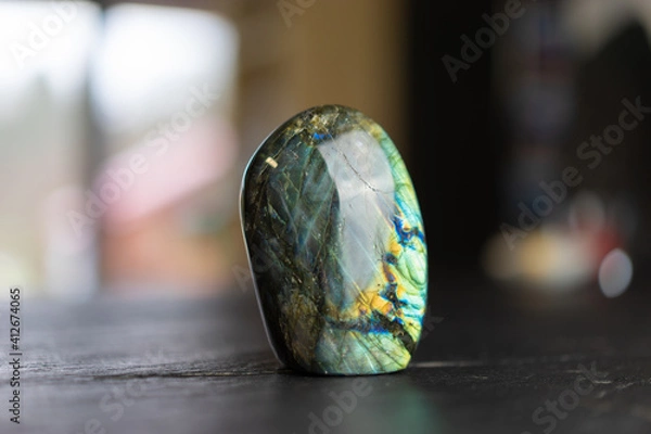 Obraz Labradorite mineral stone on slate worktop.