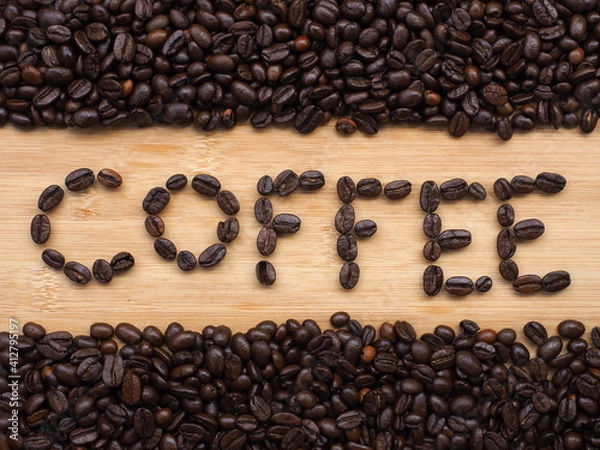 Obraz Coffee beans forming the word "Coffee" on wooden background, Coffee word made of coffee beans.