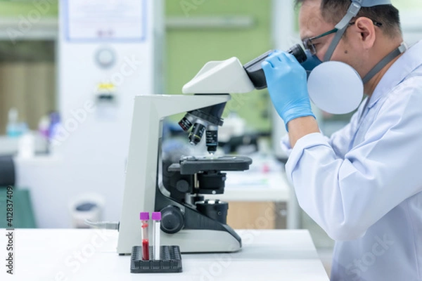 Fototapeta Scientists are studying research on the germs that cause COVID-19, the main cause of illness and are spreading in the world. (focus at tube)