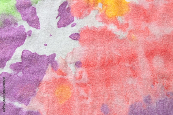 Fototapeta Pastel tie dye, a handmade pattern on a cotton t-shirt. Close-up, top view. DIY concept, handicrafts, original everyday clothes, fabric dyeing techniques. Flat lay, horizontal. Abstract background