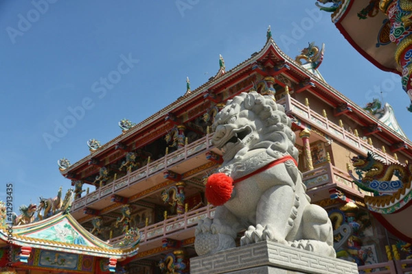 Fototapeta Lion Stone Sculpture at Wihan Thep Sathit Phra Kitthi Chalerm Shrine (Nacha Sa Thai Chue Shrine or Naja Shrine) Bang Sean, Chonburi, Thailand