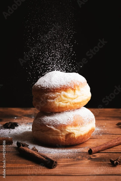 Fototapeta Donut with dropping powdered sugar
