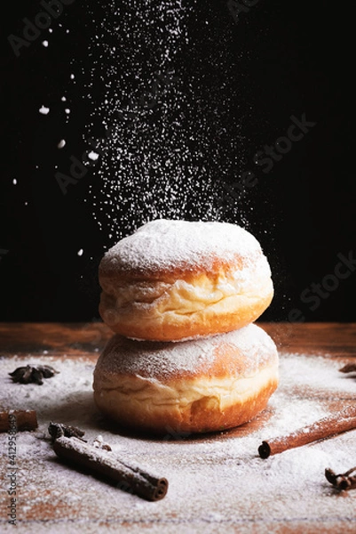 Fototapeta Donut with dropping powdered sugar
