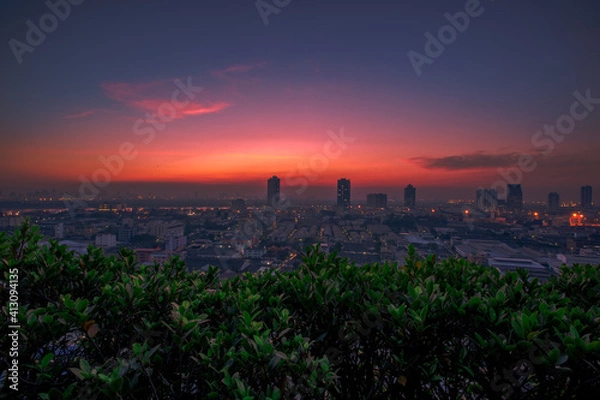 Fototapeta The blurred abstract background of the morning sun exposure to the tiny dust particles that surround the tall buildings in the capital, the long-term health issue of pollution.