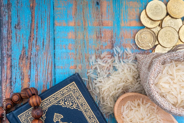 Obraz Holy Quran, Coins, Rosary and Rice. Zakat concept. Zakat is a form of alm-giving as a religious obligation