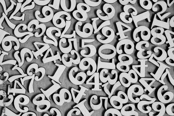 Fototapeta Wooden numbers from zero to nine on a gray background, abstract background.