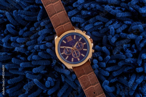 Obraz Watch with blue textured background.