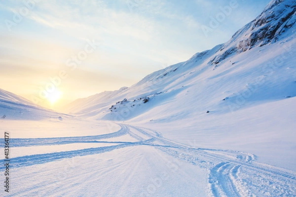 Obraz snowmobile tracks on the snow in the mountains 