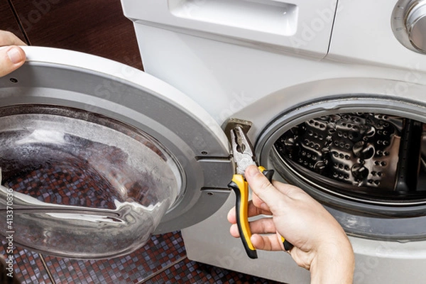 Obraz laundry washing machine repair concept. handyman fix washing appliance