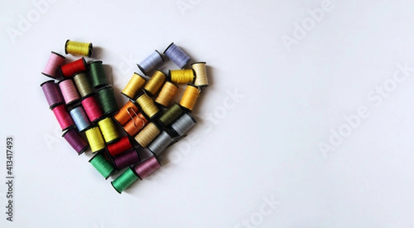 Fototapeta Heart made of multi-colored spools of thread. Concept of love for needlework Sewing, Tailor